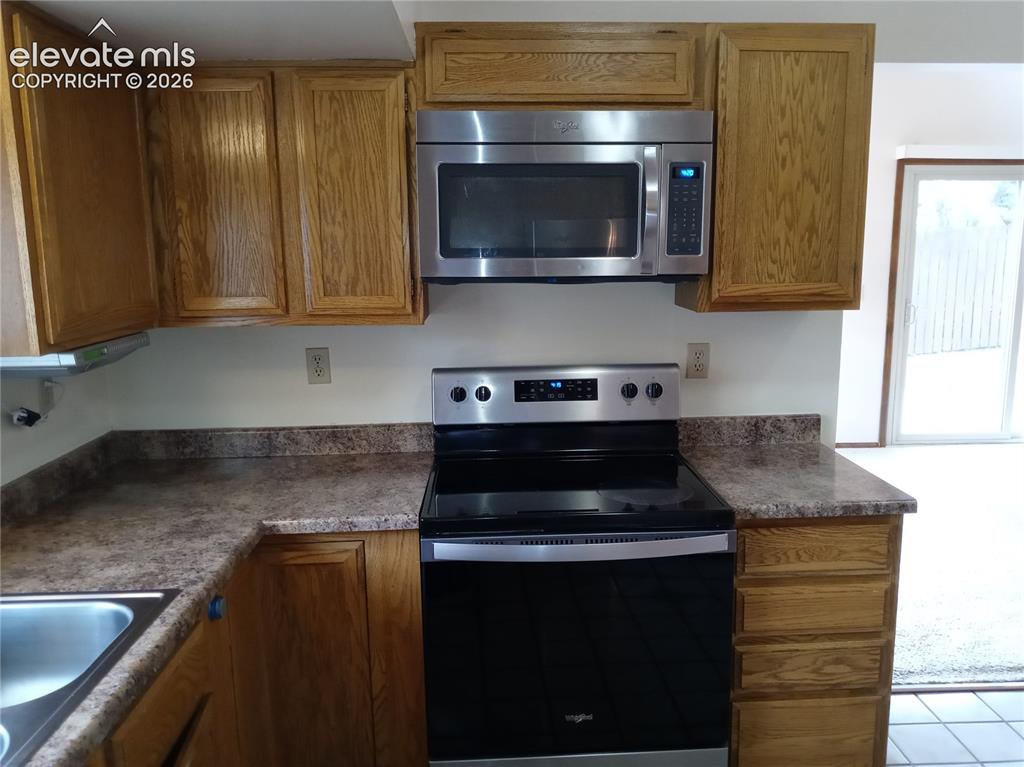Image 3 of 35: Well-appointed kitchen featuring wood-finish cabinetry, a stainless steel o