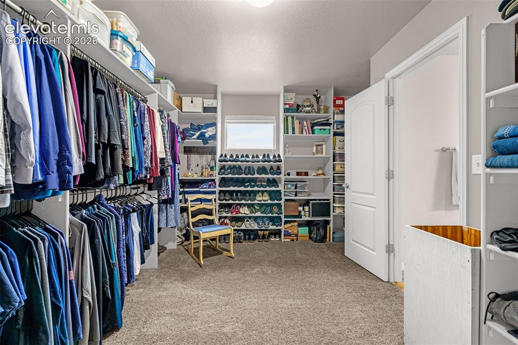 Image 23 of 42: Primary walk in closet