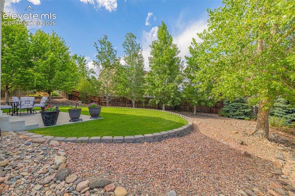 Image 36 of 42: beautifully landscaped back yard