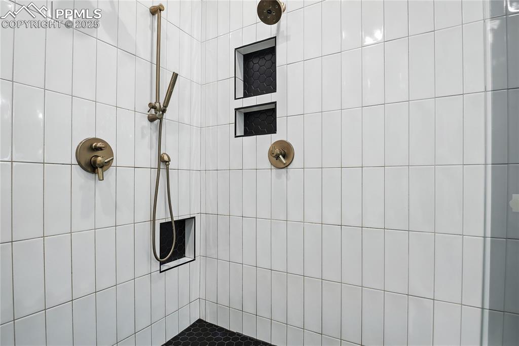 Image 29 of 50: Bathroom with a tile shower