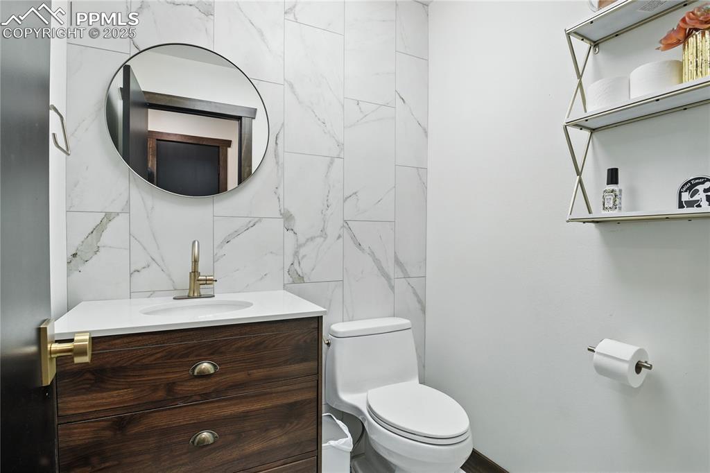 Image 38 of 50: Bathroom featuring vanity and tile walls