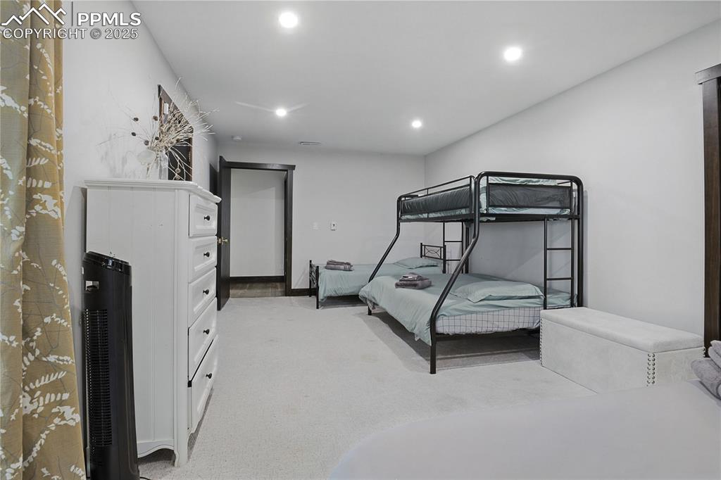 Image 41 of 50: Bedroom featuring recessed lighting and light colored carpet