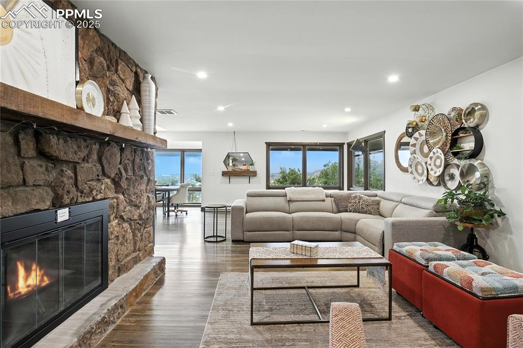 Image 5 of 50: Living area with wood finished floors, healthy amount of natural light, a f