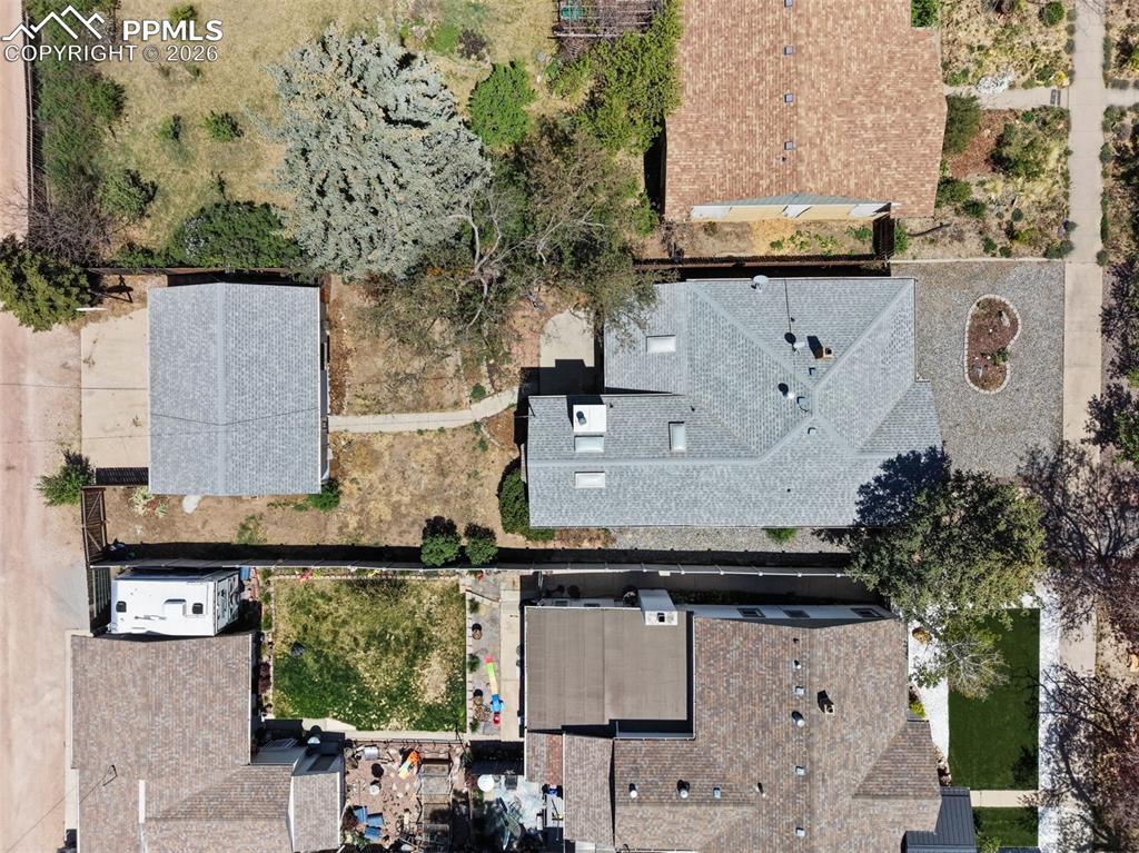 Image 50 of 50: Property featuring a main residence with a gray shingle roof and multiple s