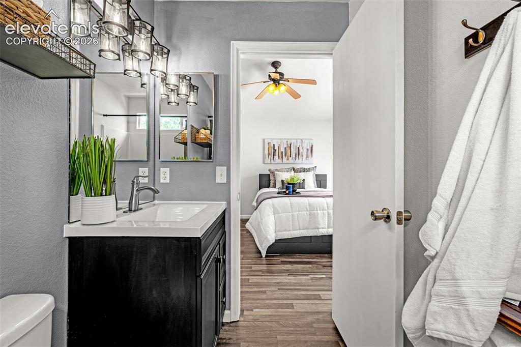 Image 17 of 49: Spacious room featuring wood-finish flooring, a vaulted ceiling, and a ceil