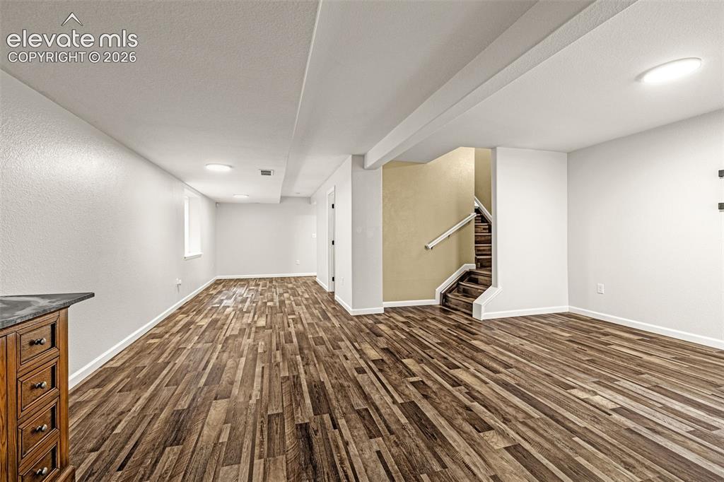 Image 19 of 49: Hallway featuring wood-finish flooring and light-toned walls