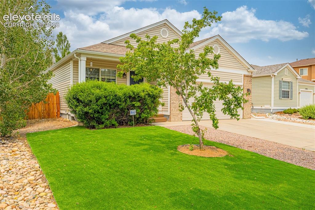 Image 3 of 49: Single-story residential exterior featuring a two-car garage, brick facade