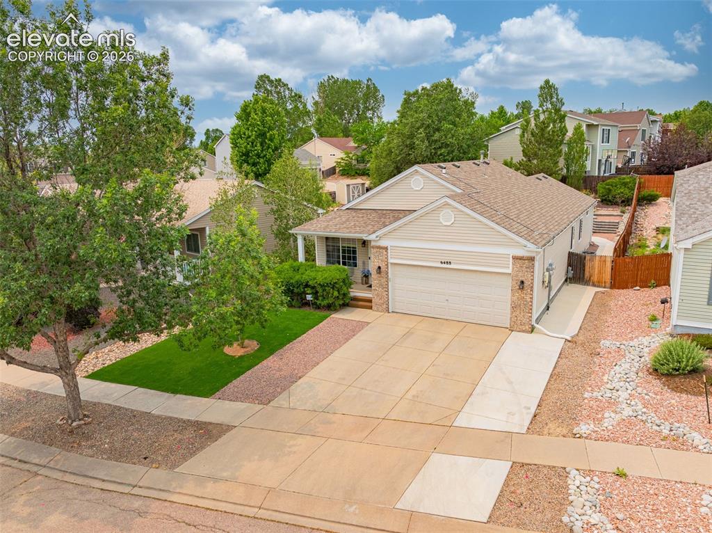 Image 37 of 49: Multi-level backyard featuring artificial turf, a paved patio, and a TUFF S