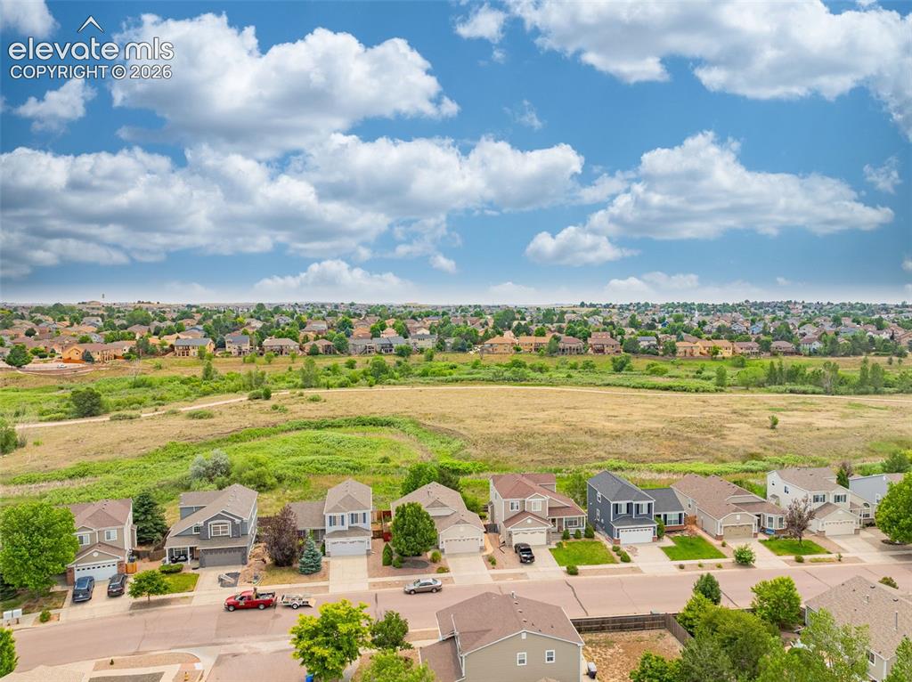 Image 42 of 49: Expansive residential area featuring numerous detached homes with diverse a