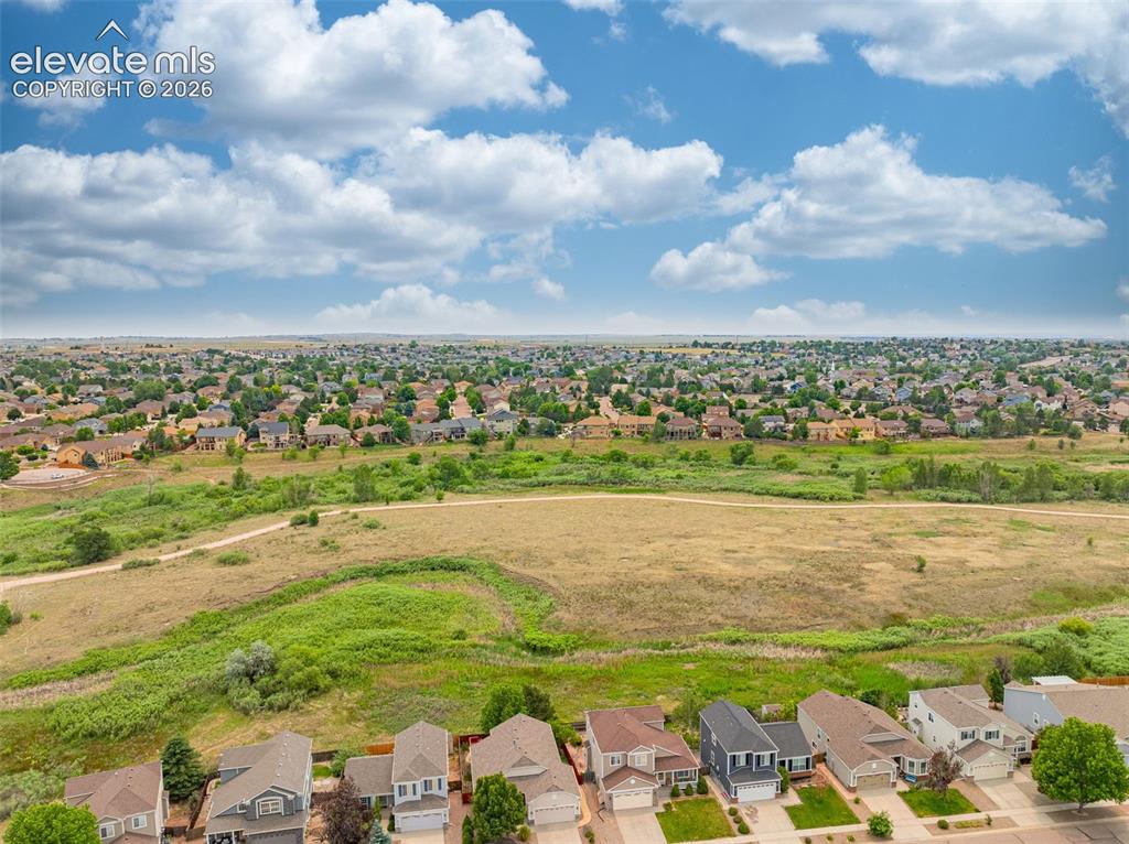 Image 44 of 49: Expansive residential neighborhood featuring numerous single-family homes w