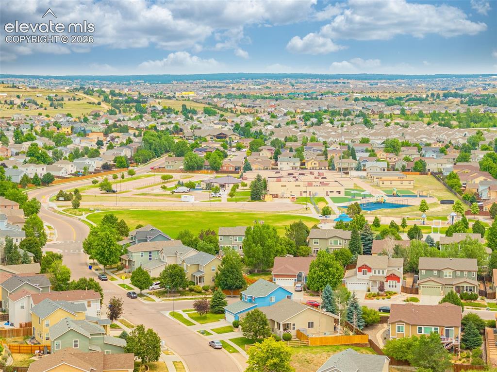 Image 45 of 49: Aerial perspective of a suburban neighborhood featuring residential homes,