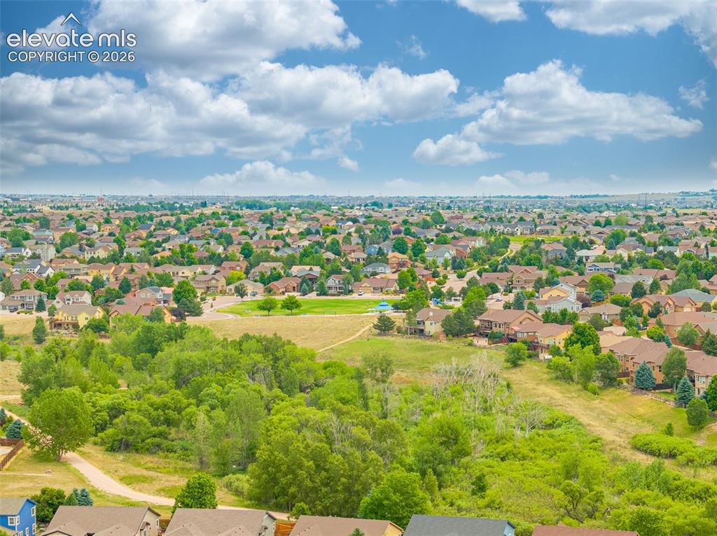 Image 46 of 49: Expansive residential area featuring numerous detached homes, curving stree