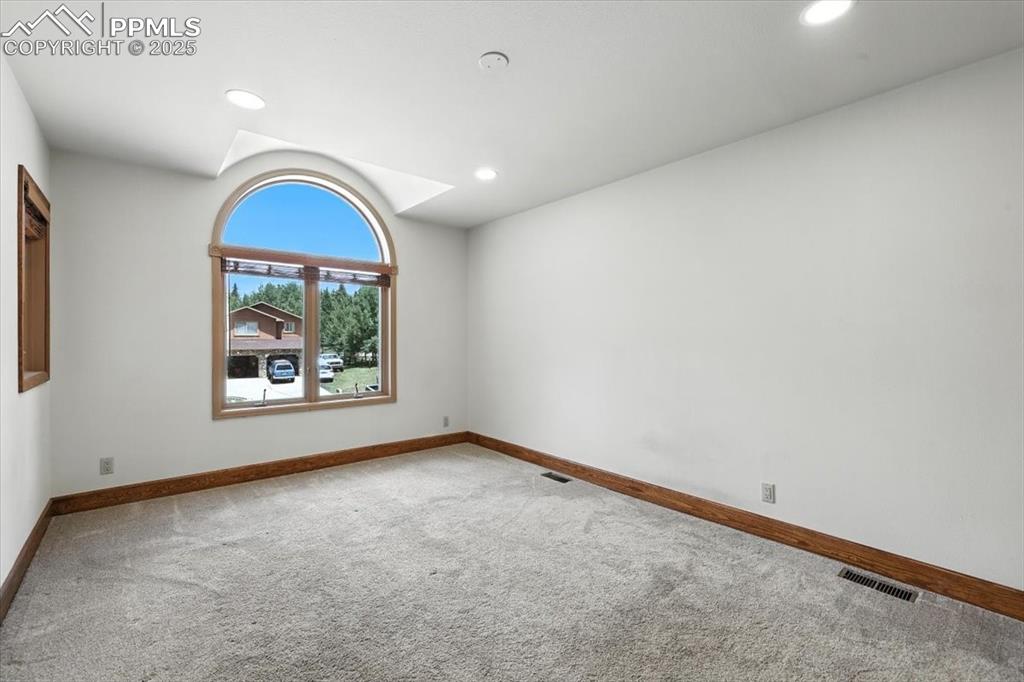 Image 14 of 36: Unfurnished room featuring carpet flooring, lofted ceiling, and recessed li
