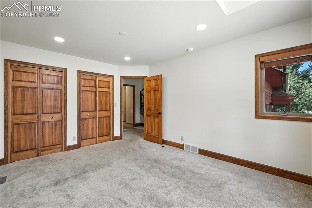 Image 15 of 36: Unfurnished bedroom with two closets, carpet, and recessed lighting