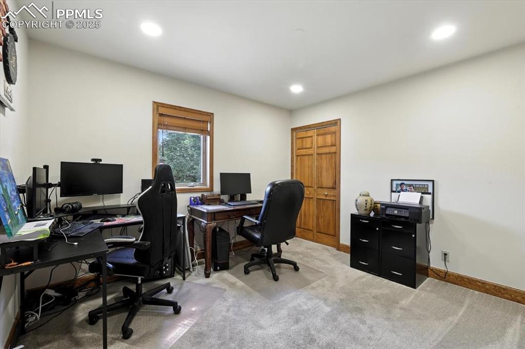 Image 16 of 36: Office with light colored carpet and recessed lighting