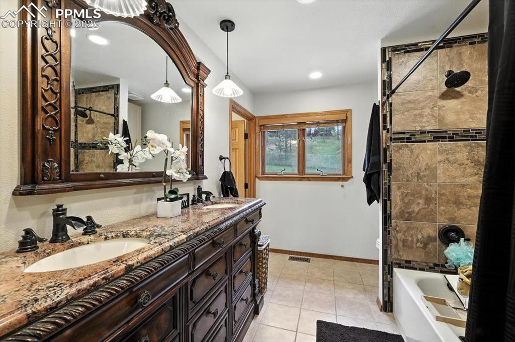 Image 17 of 36: Full bath featuring double vanity, tile patterned floors, recessed lighting