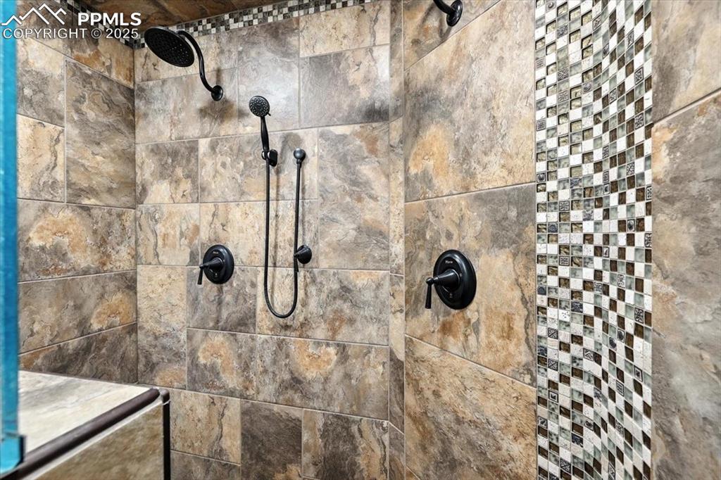 Image 23 of 36: Bathroom view of a tile shower
