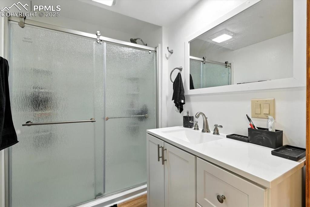 Image 26 of 36: Full bathroom featuring vanity and a shower stall