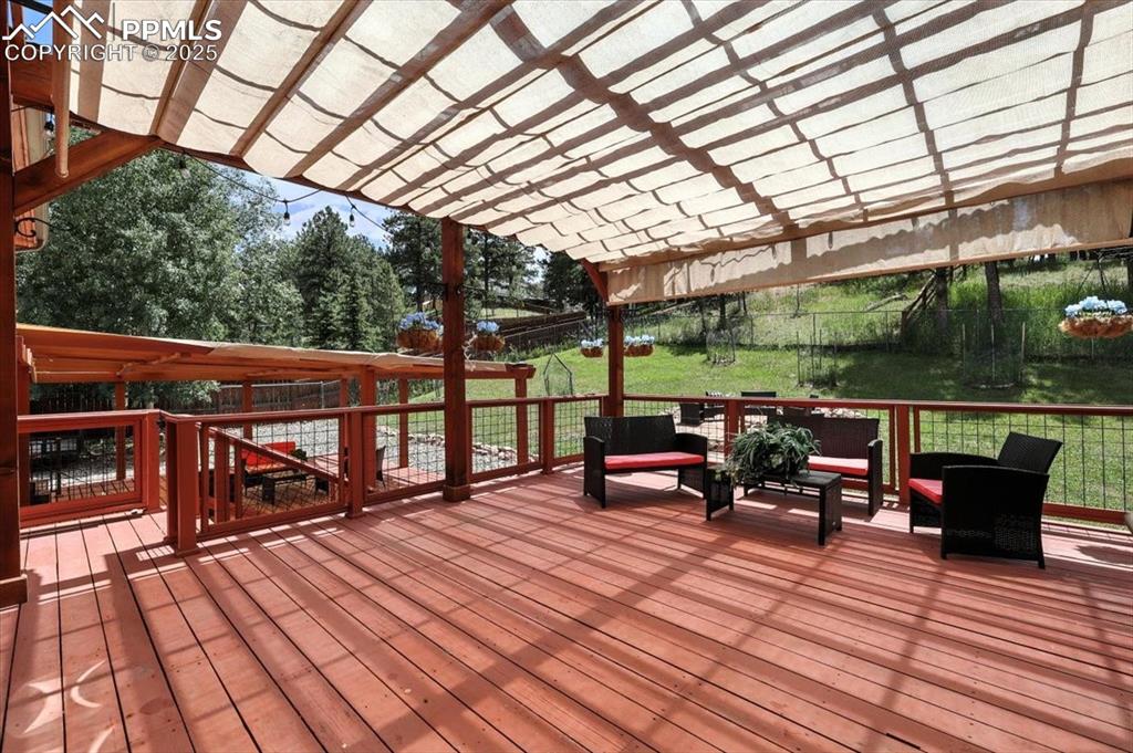 Image 29 of 36: Deck featuring a fenced backyard, a pergola, and outdoor lounge area