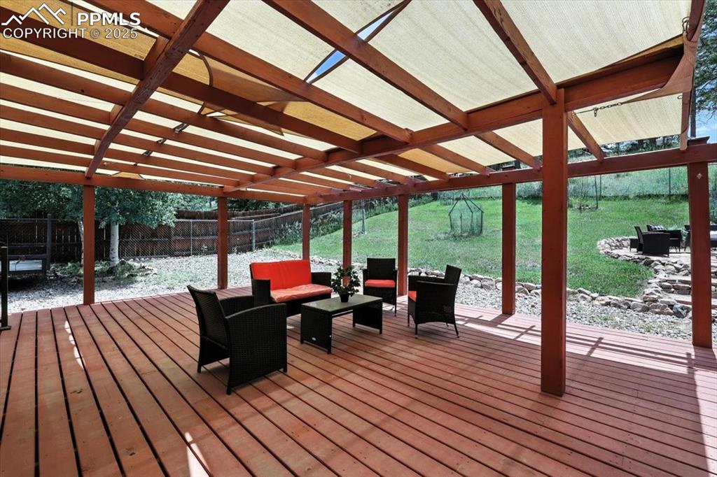 Image 30 of 36: Wooden deck featuring a pergola, an outdoor living space, and a fenced back
