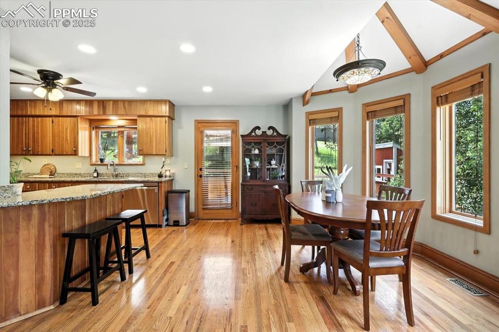 Image 6 of 36: Dining space with light wood-style flooring, healthy amount of natural ligh