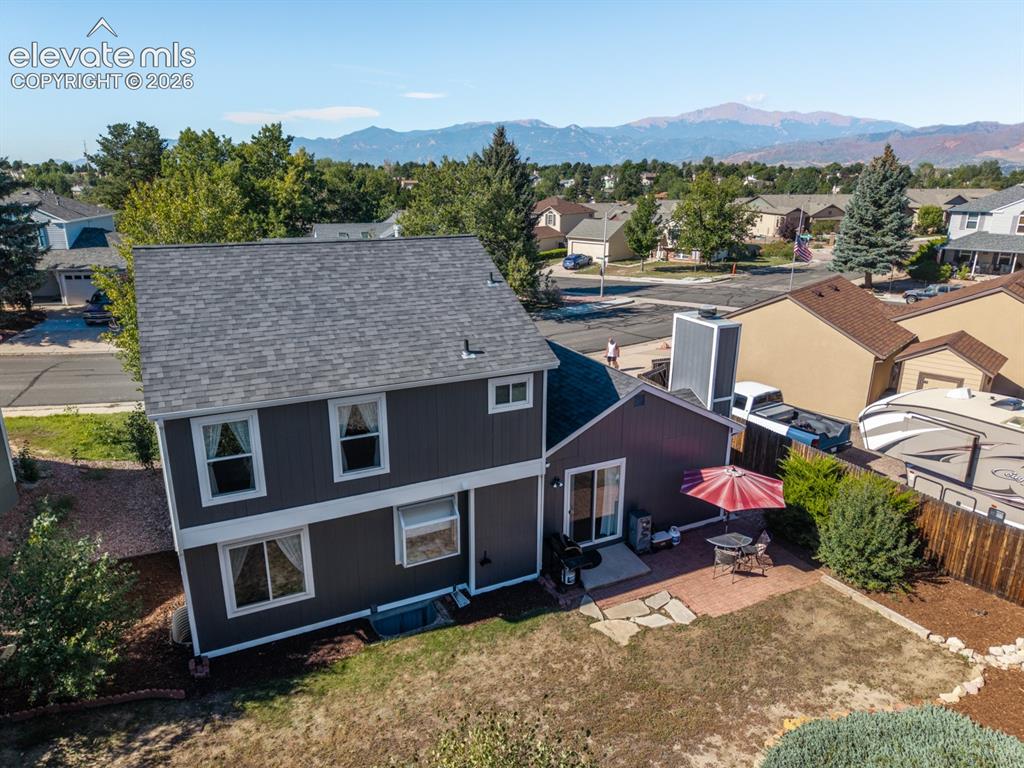 Image 37 of 41: Two-story home with a dark gray exterior and white trim, featuring a gray s