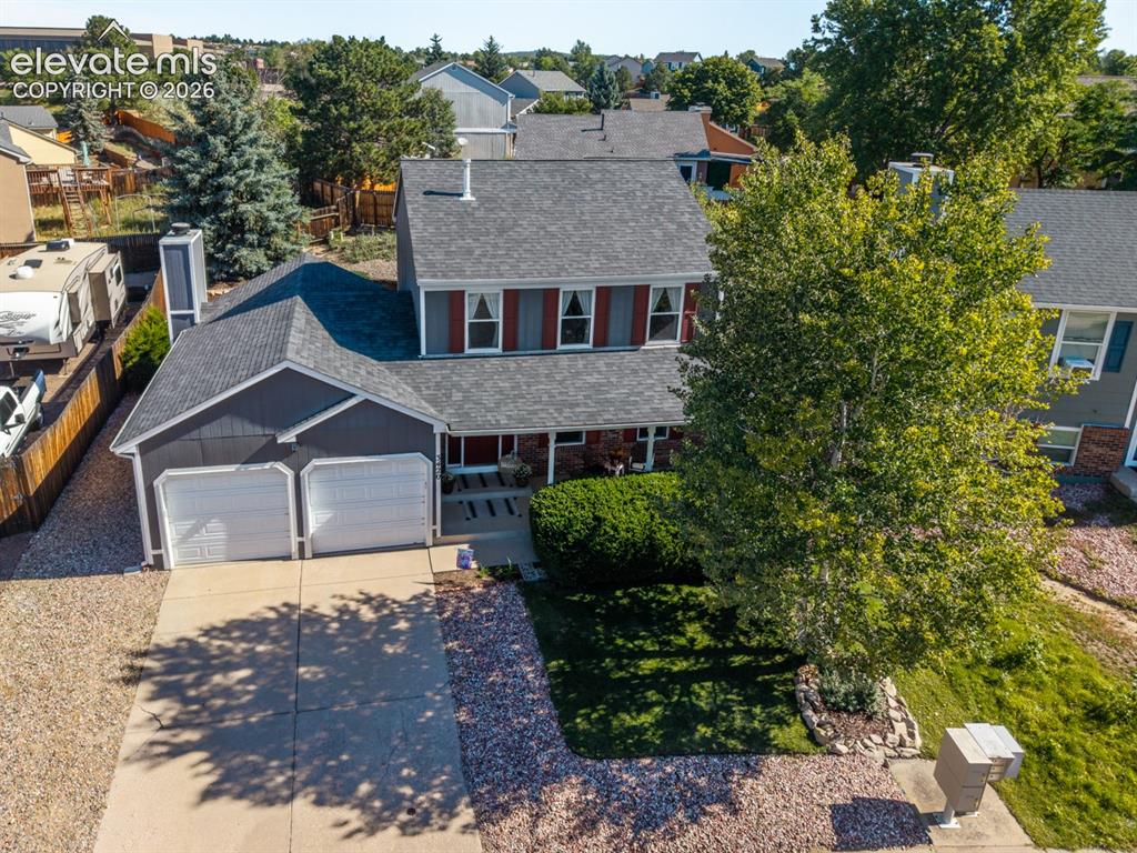 Image 39 of 41: Two-car garage, concrete driveway, and mature landscaping