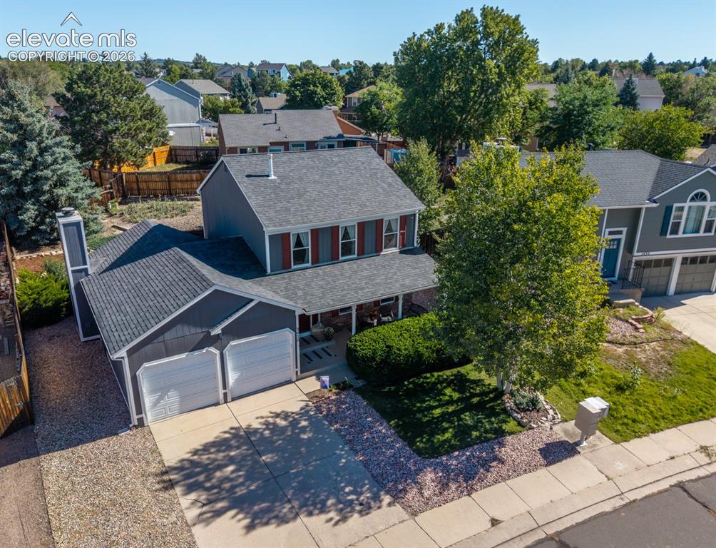 Image 40 of 41: Two-story residence with a covered front porch, attached two-car garage, an