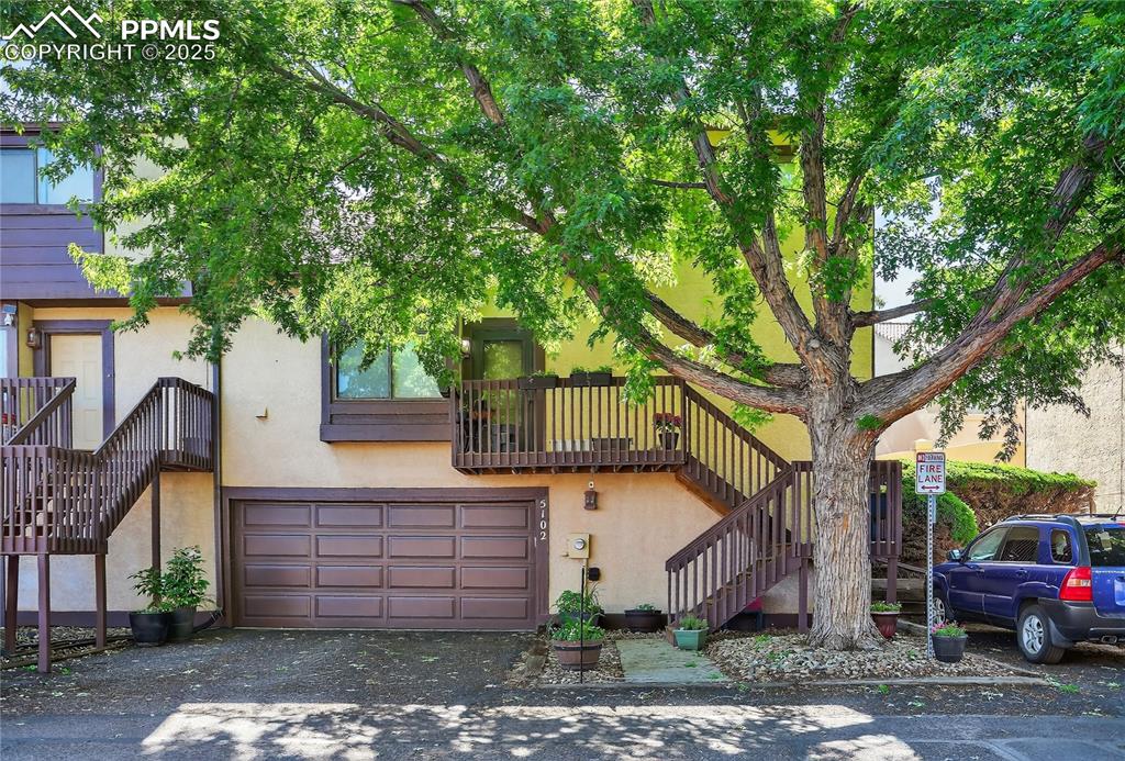 Caption: Townhome featuring stucco siding, and a 2 car garage