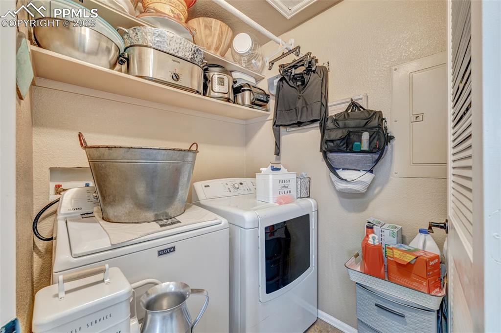 Image 11 of 23: Laundry area featuring electric panel, independent washer and dryer, laundr