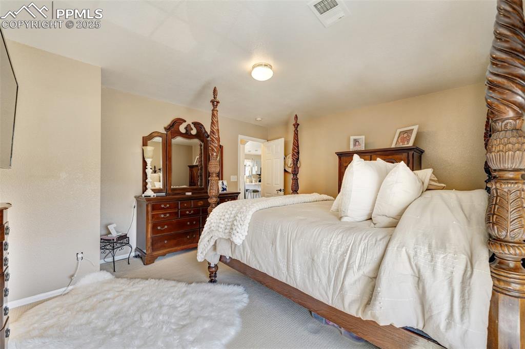 Image 13 of 23: Bedroom with baseboards, carpet, and visible vents