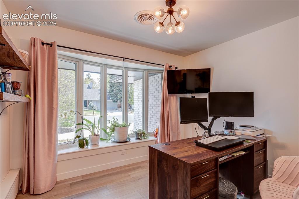 Image 25 of 50: Bay window with a deep sill and light wood-finish flooring