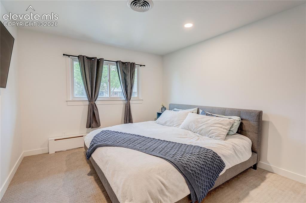 Image 29 of 50: Recessed ceiling lighting, white wall finishes, window with white trim, and