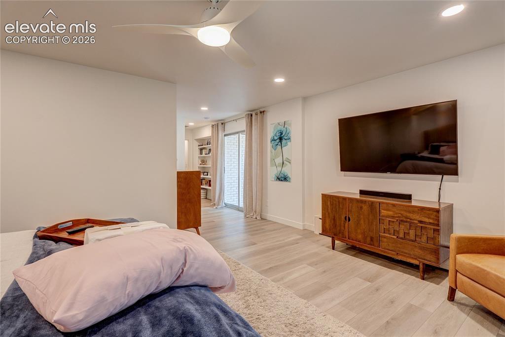 Image 34 of 50: Recessed lighting, light wood-finish flooring, ceiling fan with integrated