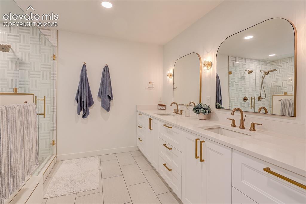 Image 36 of 50: Double vanity featuring undermount sinks and brass-finish fixtures