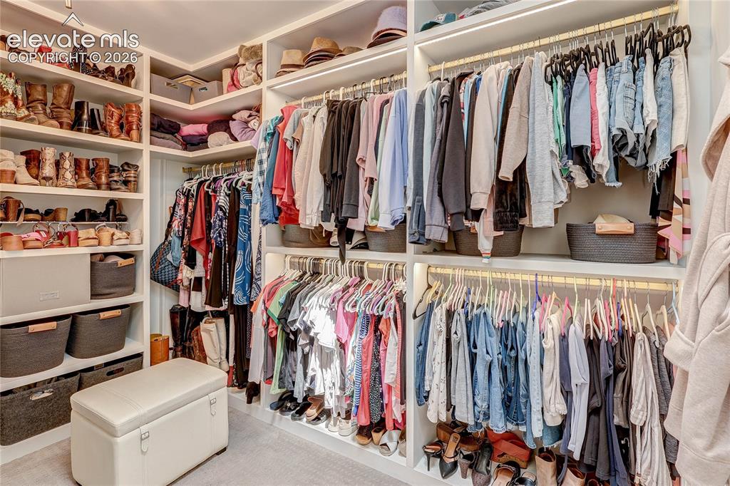 Image 37 of 50: Custom closet system featuring built-in shelving, clothing rods, and integr