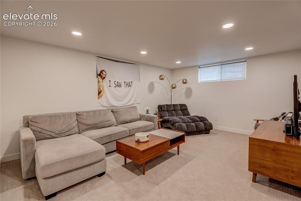 Image 46 of 50: Recessed lighting throughout, neutral-toned walls, and carpet flooring