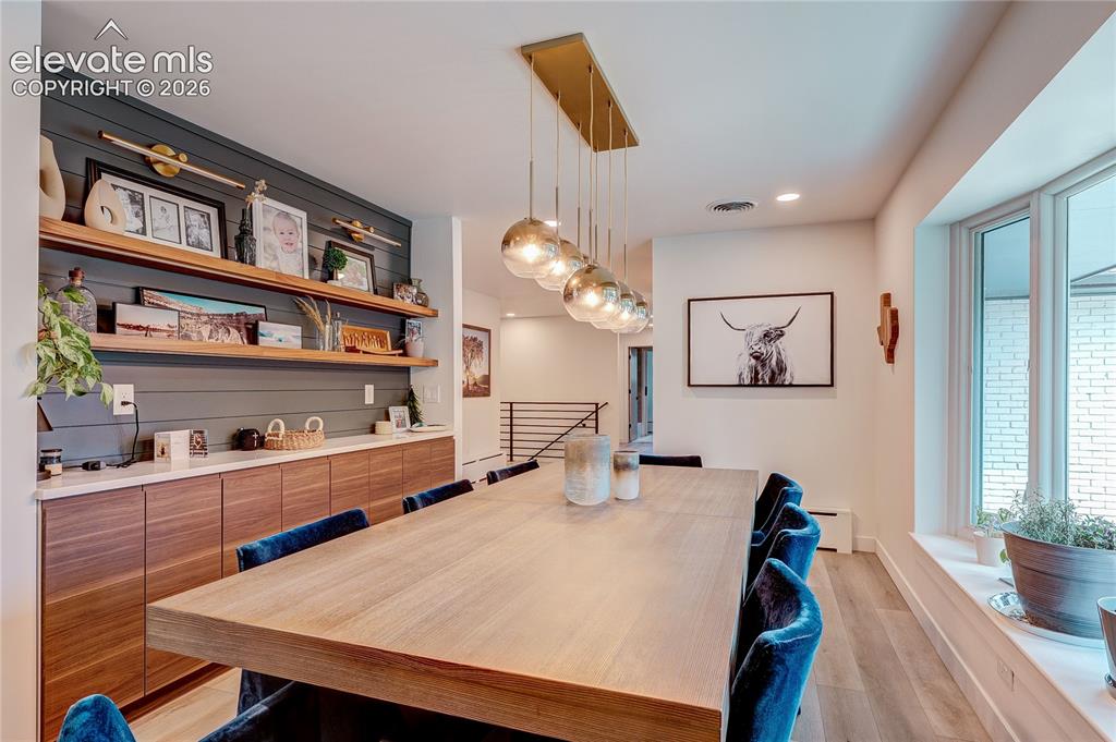 Image 7 of 50: Built-in cabinetry with wood-finish doors and white countertops, shiplap wa