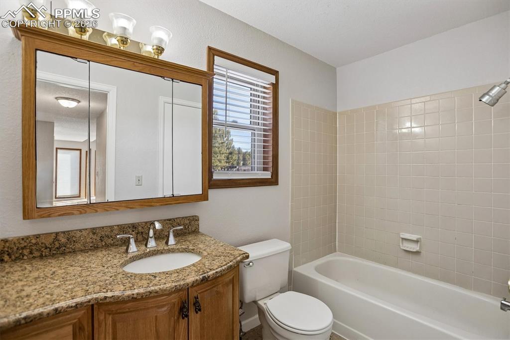 Image 17 of 29: Bathroom featuring vanity and shower / washtub combination