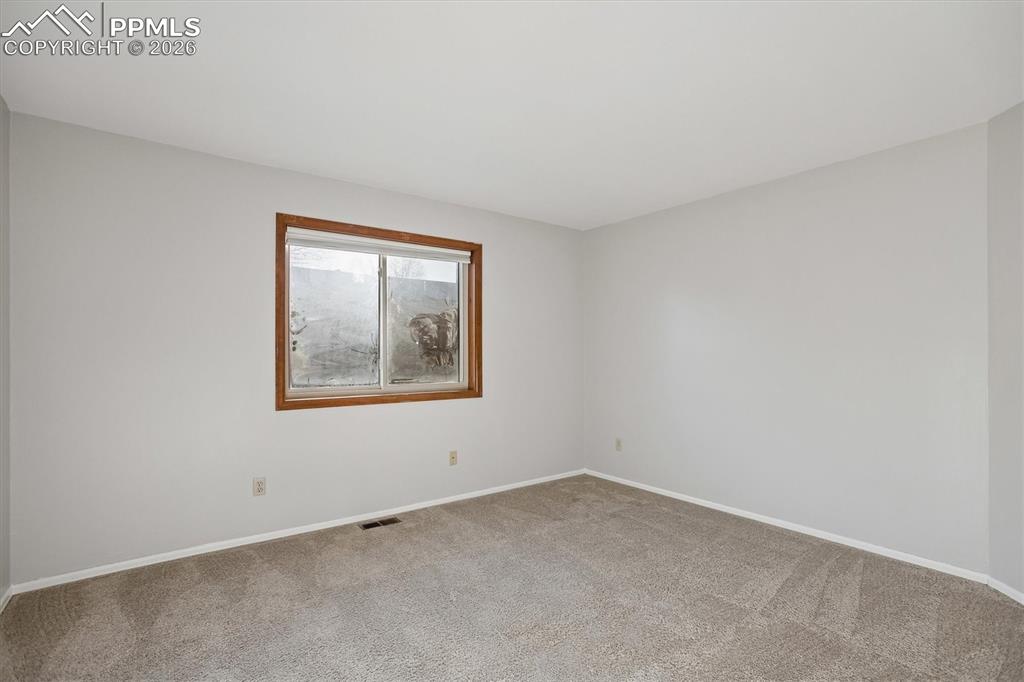 Image 18 of 29: Carpeted empty room featuring baseboards