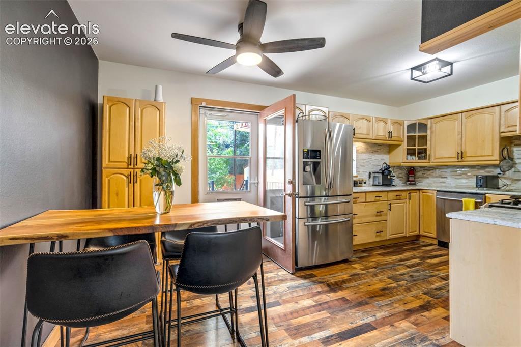 Image 18 of 50: Kitchen featuring wood-finish flooring, stainless steel appliances, light w