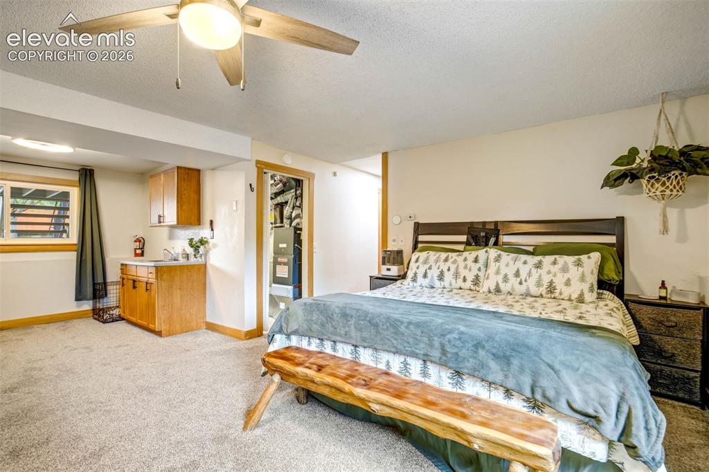 Image 27 of 50: Recessed lighting and a ceiling fan illuminate this space featuring a built