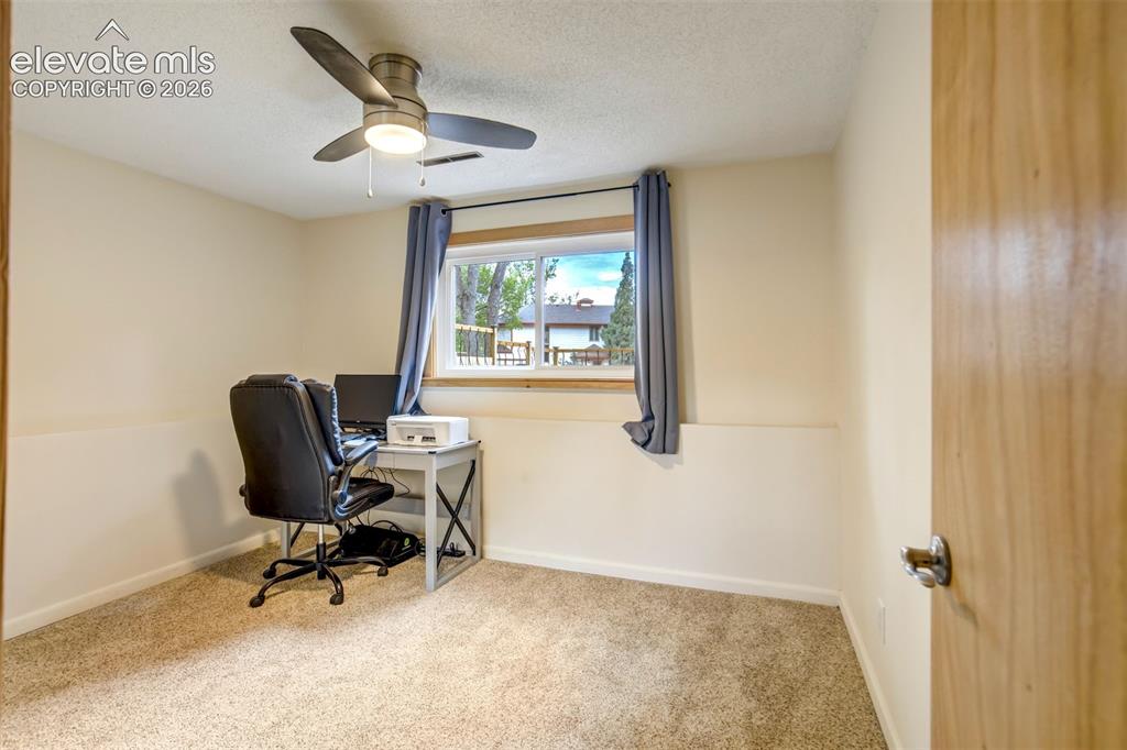 Image 30 of 50: Bedroom featuring neutral carpeting, light-toned walls, and a window with a