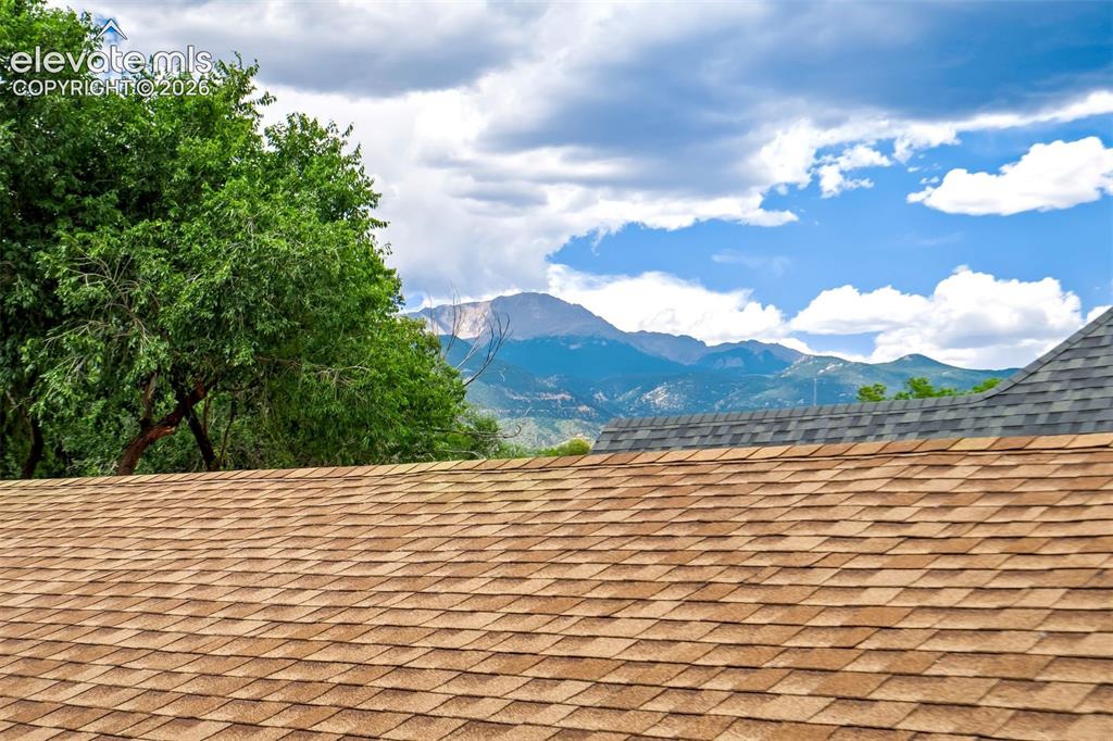 Image 34 of 50: Roofline featuring brown architectural shingles and partial grey architectu