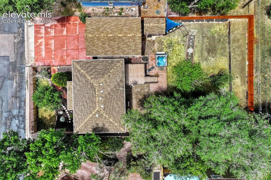 Image 44 of 50: Elevated aerial perspective showcasing property with multiple roofing struc