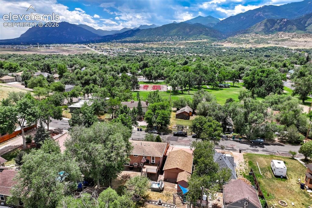 Image 45 of 50: Mountainous terrain surrounds a residential area with varied housing styles