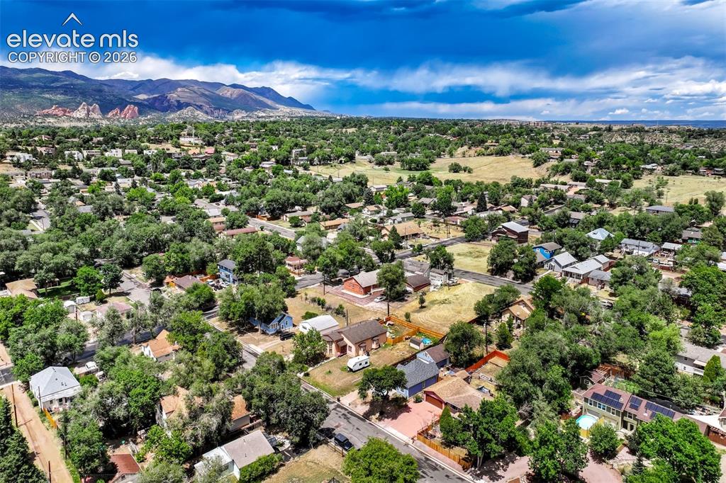 Image 49 of 50: Expansive aerial perspective showcasing a residential area with mature tree