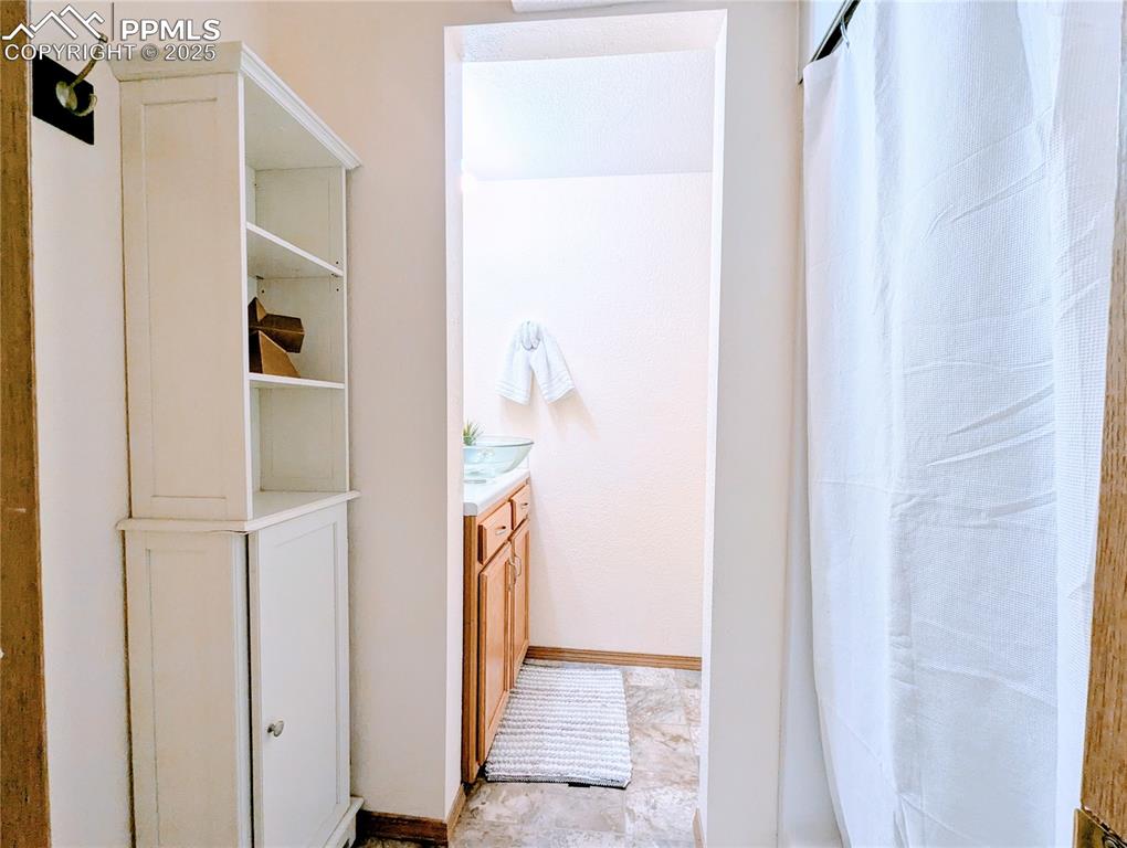 Image 11 of 19: Bathroom with vanity and a shower with curtain