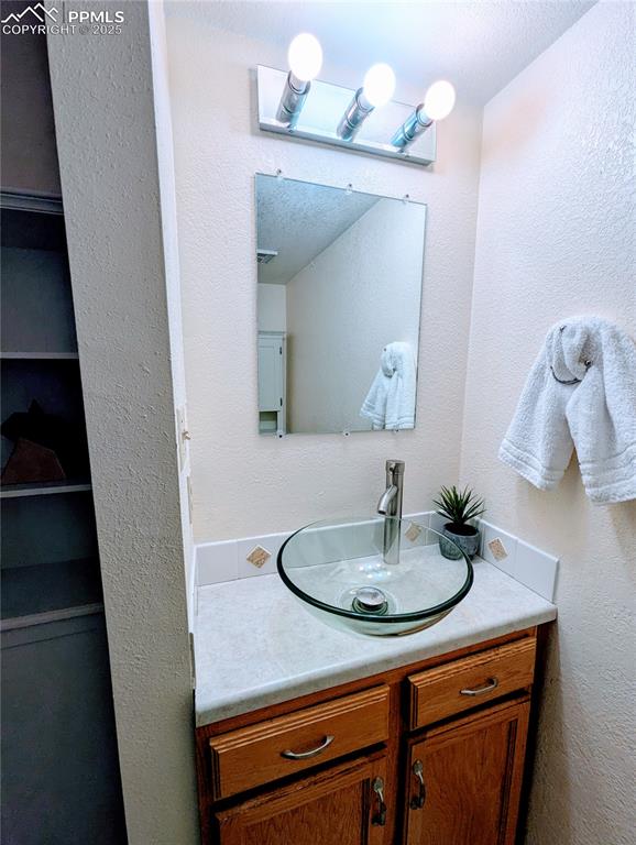 Image 13 of 19: Bathroom and vanity