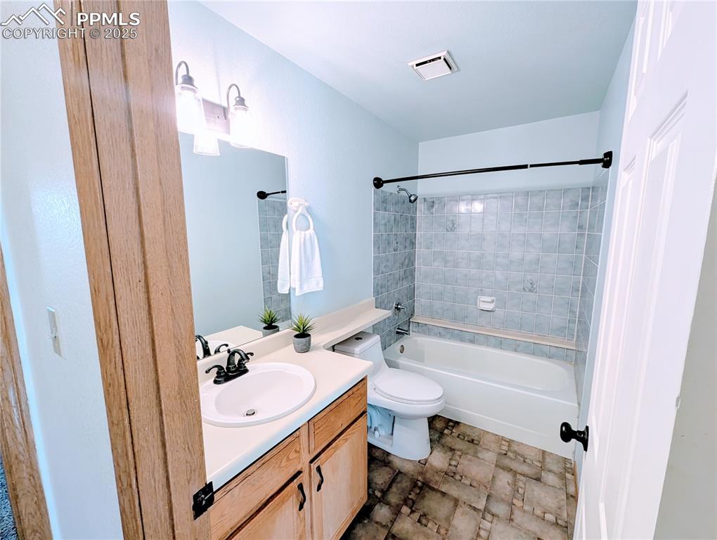 Image 8 of 19: Bathroom with vanity and shower / washtub combination